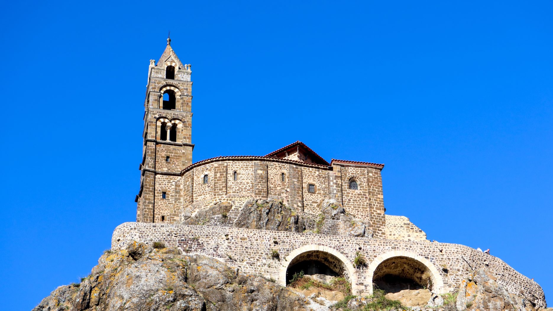 A 1000 year old stone building sits atop a spike of volcanic rock.